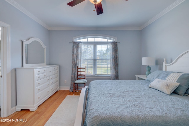 bedroom with crown molding, light hardwood / wood-style floors, and ceiling fan