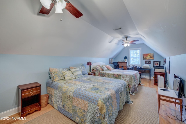 bedroom with light hardwood / wood-style floors, vaulted ceiling, and ceiling fan