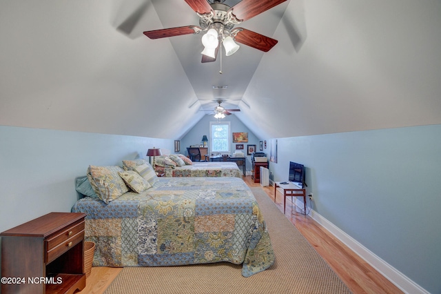 bedroom featuring lofted ceiling, wood-type flooring, and ceiling fan