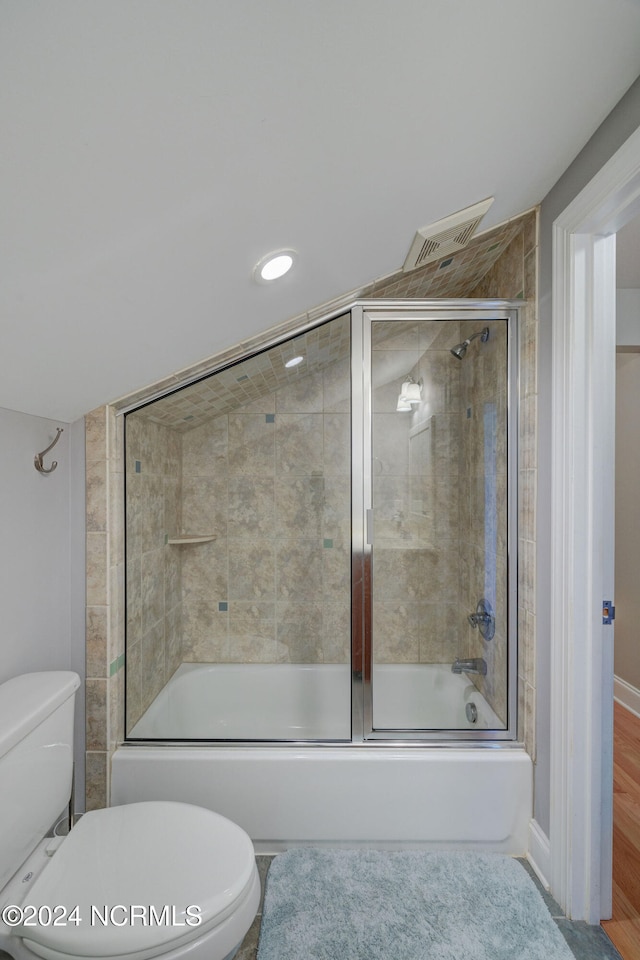 bathroom featuring toilet, enclosed tub / shower combo, and wood-type flooring