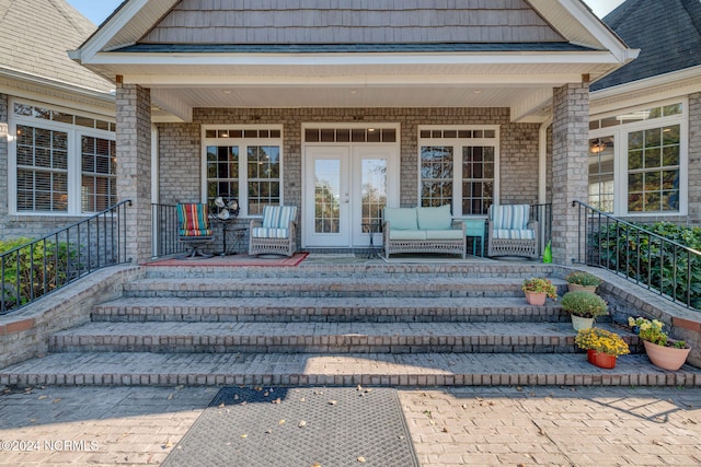 doorway to property featuring french doors and a porch