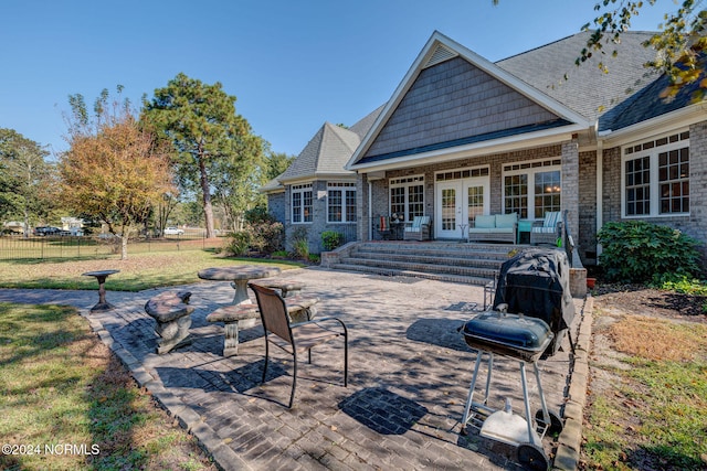 back of property featuring french doors, a patio, and a yard