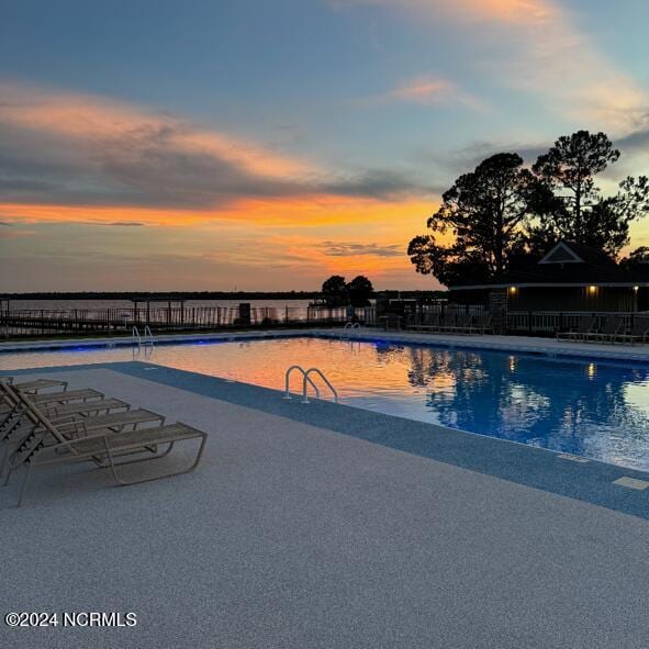 view of pool at dusk