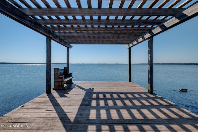 view of dock with a water view and a pergola