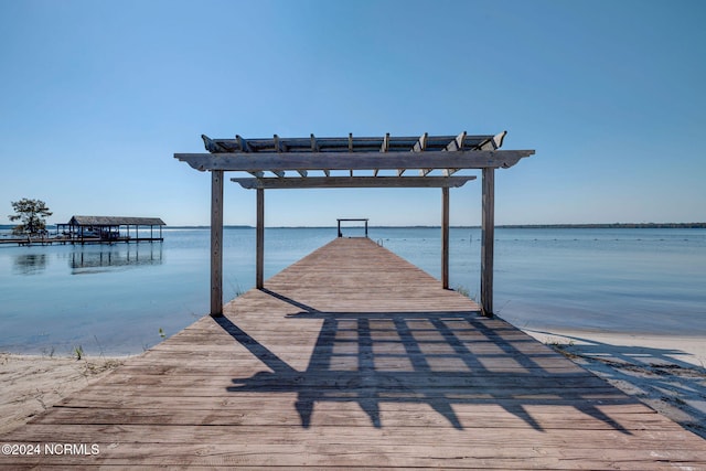 dock area featuring a water view and a pergola