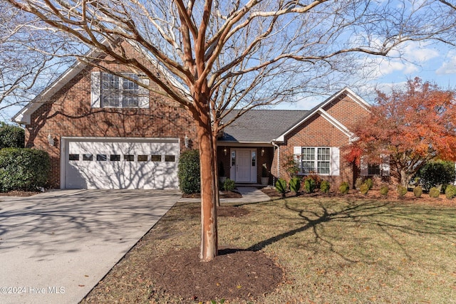 view of front of house with a garage and a front lawn