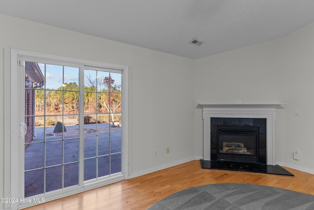 unfurnished living room with wood-type flooring