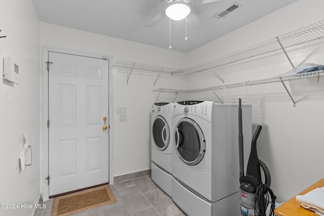 clothes washing area featuring ceiling fan, washer and clothes dryer, and light tile patterned floors