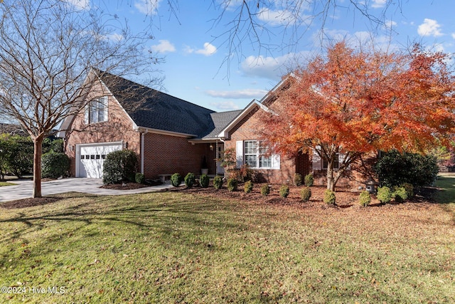 view of front facade with a front yard and a garage