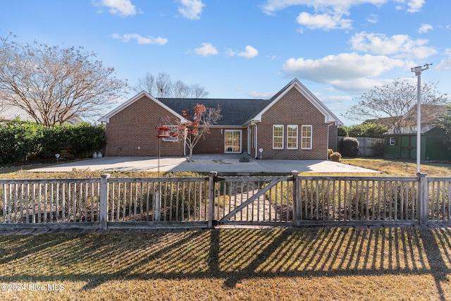 7319 Thurgood Rd, Wilmington, NC 28411 - back of house featuring brick siding and a patio area