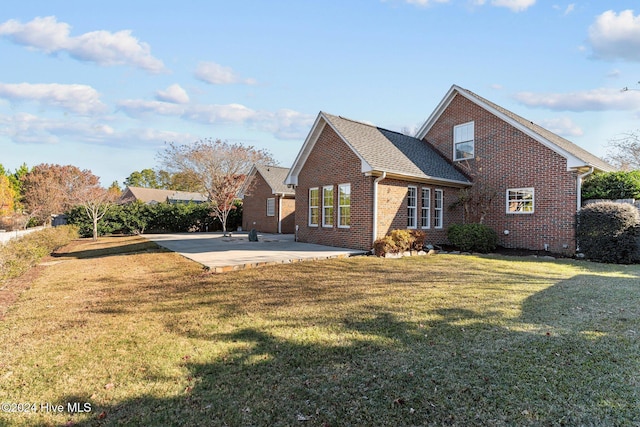7319 Thurgood Rd, Wilmington, NC 28411 - back of property featuring brick siding, a patio, and a lawn