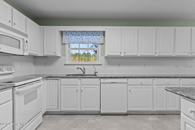 kitchen with white cabinets, decorative backsplash, white appliances, and sink