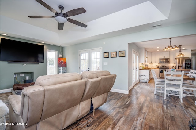 living room featuring french doors, ceiling fan, and dark hardwood / wood-style flooring