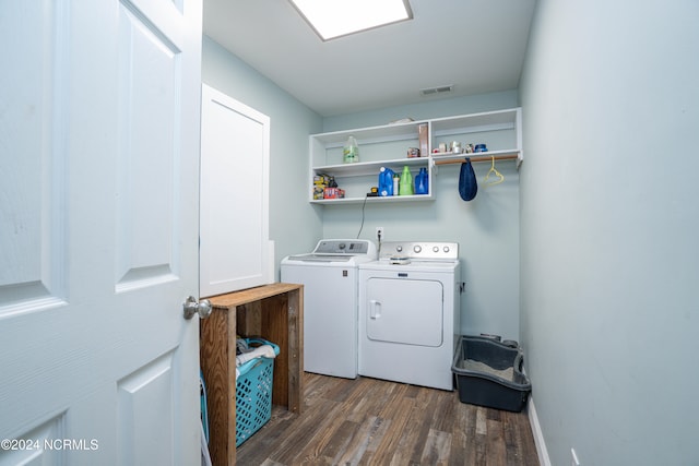 laundry area featuring dark wood-type flooring and washing machine and clothes dryer