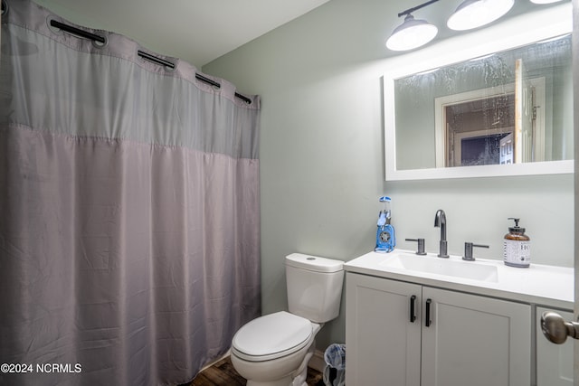 bathroom with vanity, a shower with curtain, toilet, and hardwood / wood-style flooring