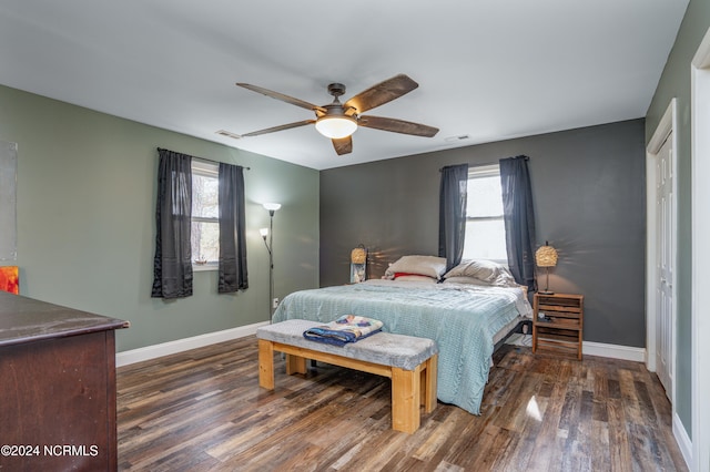 bedroom with dark hardwood / wood-style floors and ceiling fan