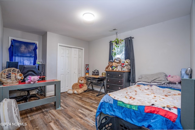 bedroom with a closet and hardwood / wood-style floors