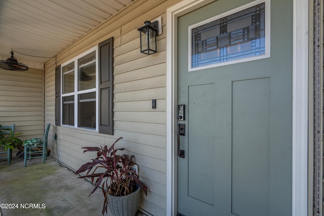 view of exterior entry with covered porch