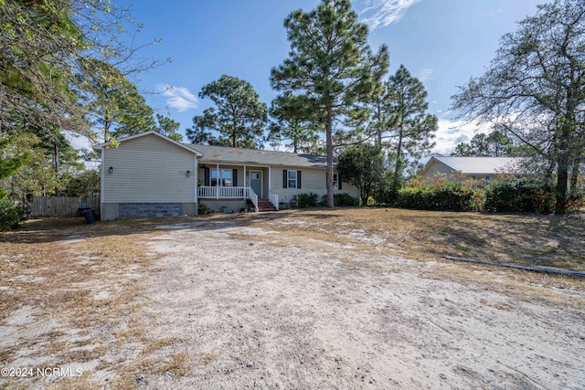 single story home with a porch