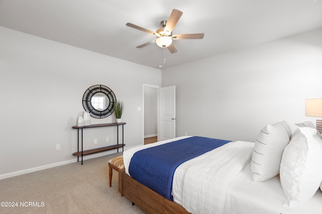 bedroom featuring light colored carpet and ceiling fan