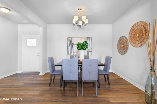 dining space featuring an inviting chandelier and dark hardwood / wood-style floors