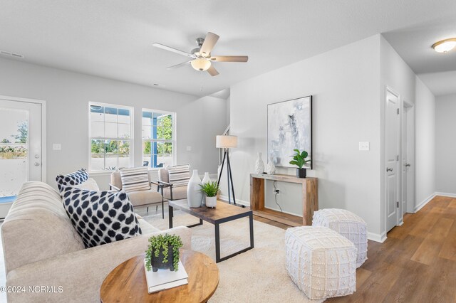 living room featuring hardwood / wood-style flooring and ceiling fan