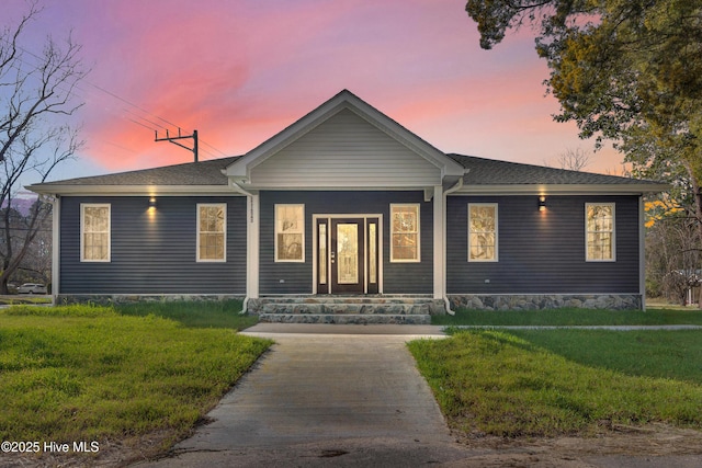 single story home featuring a front yard