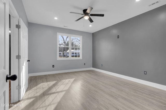 empty room with recessed lighting, visible vents, light wood-style flooring, a ceiling fan, and baseboards