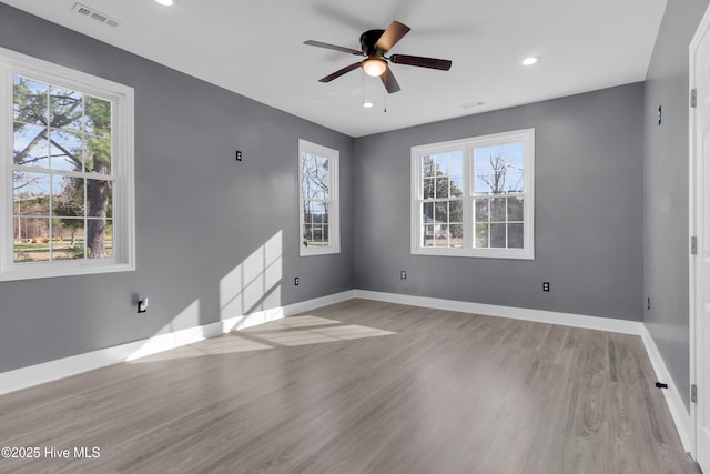 unfurnished room featuring recessed lighting, visible vents, a ceiling fan, wood finished floors, and baseboards