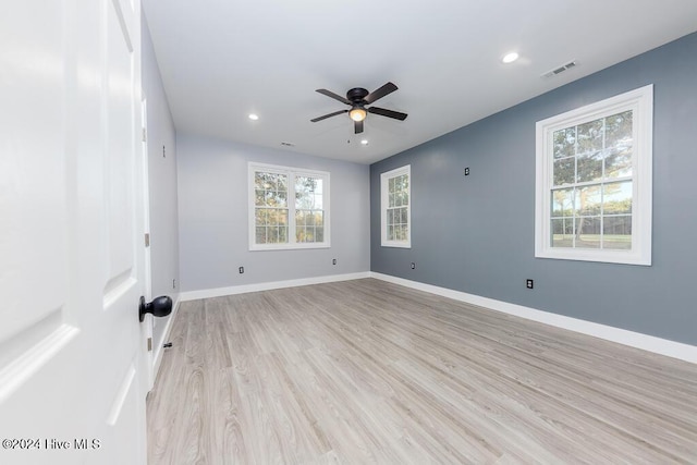 empty room featuring ceiling fan and light hardwood / wood-style flooring