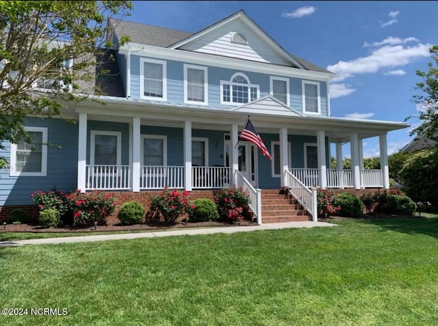 view of front of property featuring covered porch and a front lawn