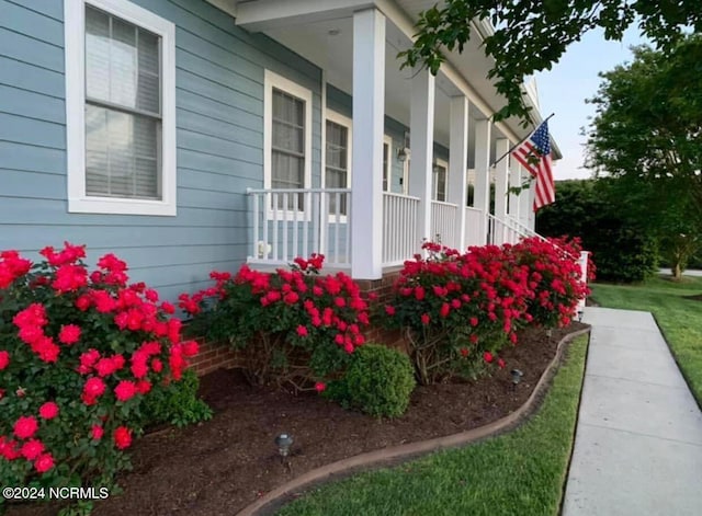 view of property exterior with covered porch