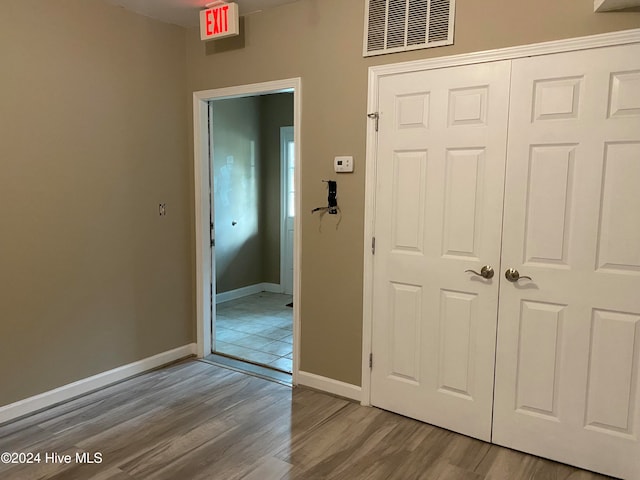 hallway with wood-type flooring