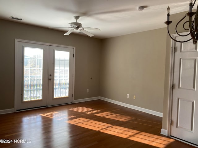 unfurnished room with ceiling fan, french doors, and dark wood-type flooring