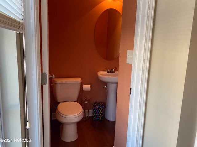 bathroom featuring hardwood / wood-style floors and toilet