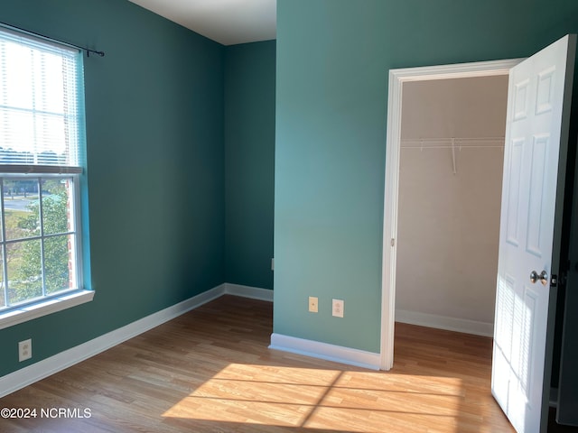 unfurnished bedroom featuring a closet and light hardwood / wood-style floors