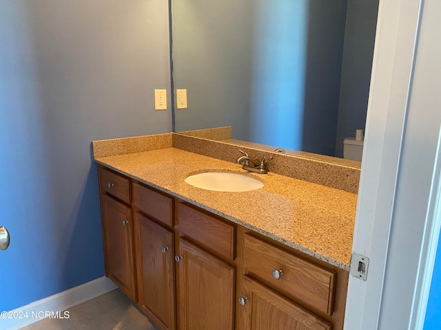 bathroom featuring tile patterned floors, vanity, and toilet