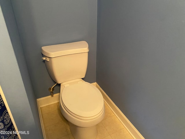 bathroom with tile patterned flooring and toilet