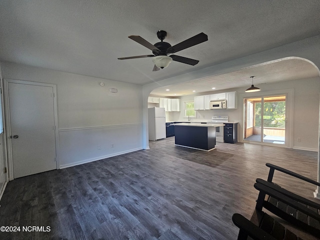 unfurnished living room with a textured ceiling, ceiling fan, sink, and dark hardwood / wood-style flooring