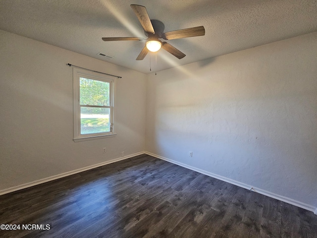 unfurnished room featuring a textured ceiling, dark hardwood / wood-style floors, and ceiling fan