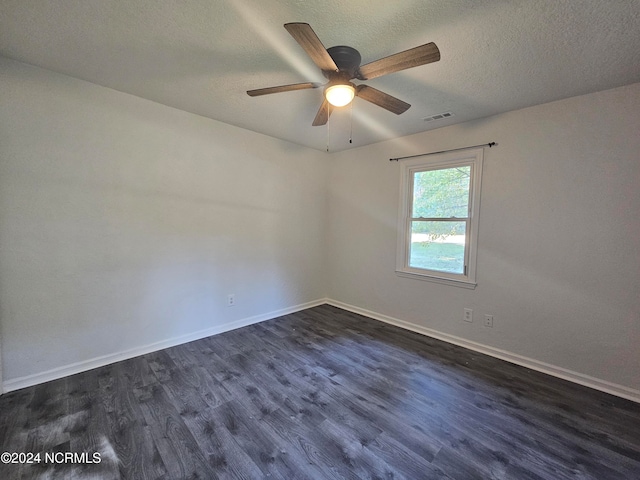 empty room with a textured ceiling, ceiling fan, and dark hardwood / wood-style flooring