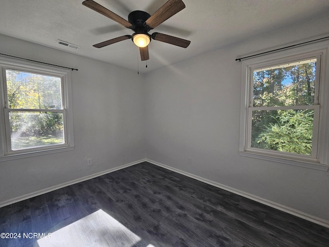 unfurnished room with ceiling fan, a textured ceiling, and dark hardwood / wood-style flooring