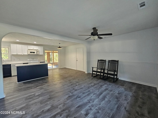 unfurnished living room with a textured ceiling, ceiling fan, and dark hardwood / wood-style flooring