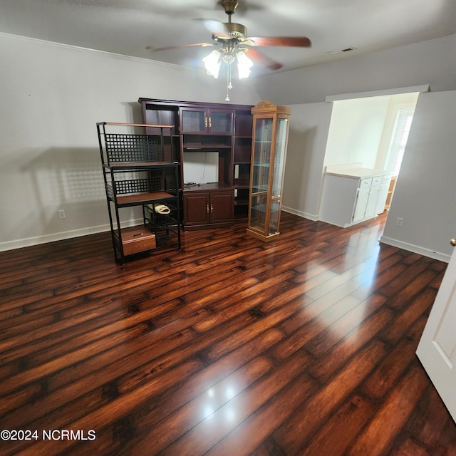 unfurnished office with ornamental molding, ceiling fan, and dark hardwood / wood-style flooring