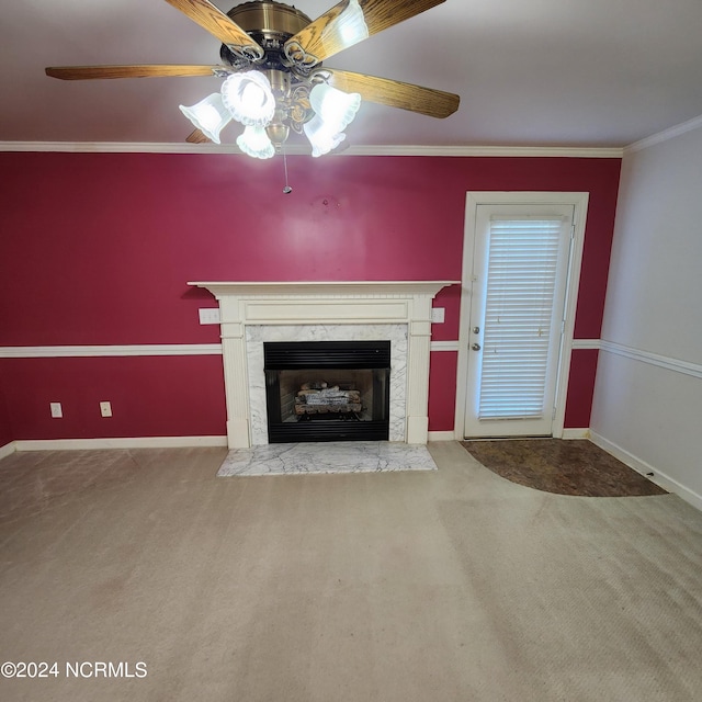 unfurnished living room with ceiling fan, crown molding, carpet, and a premium fireplace