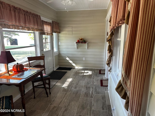 unfurnished sunroom featuring ceiling fan