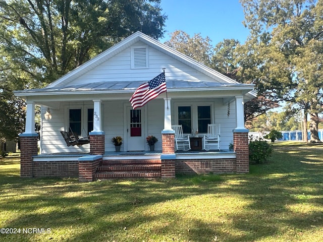 view of front of house featuring a front yard and covered porch