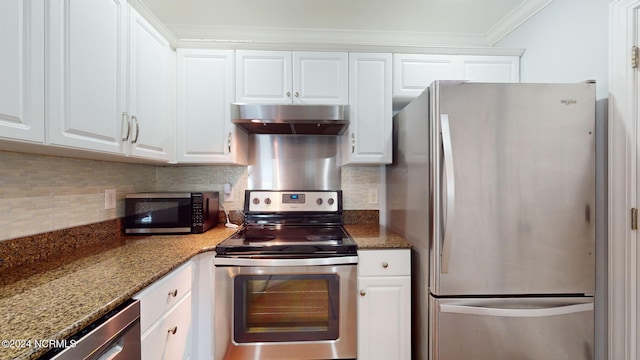 kitchen featuring white cabinets, stainless steel appliances, range hood, and dark stone counters