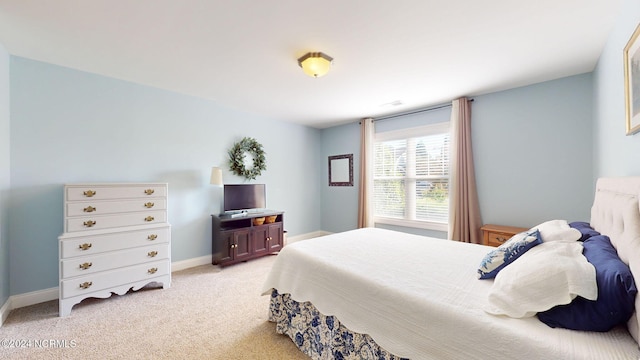 bedroom featuring light carpet