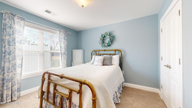 bedroom with light colored carpet and a closet